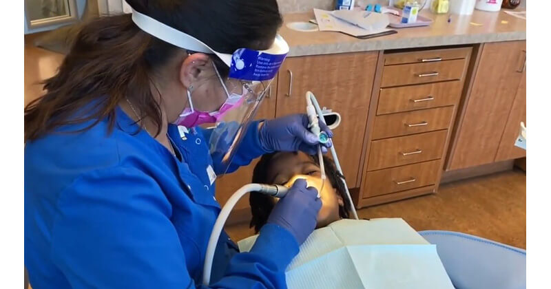 Dr. Kanuga applies ClearShield Varnish during a routine prophylaxis appointment